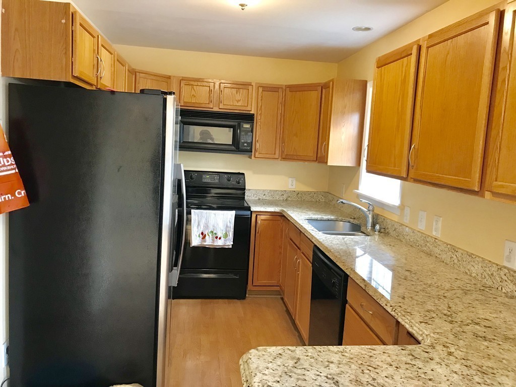 167 Orient Street Worcester, MA 01604 - Photo 9 of 29 a kitchen with stainless steel appliances granite countertop a refrigerator a stove and a sink
