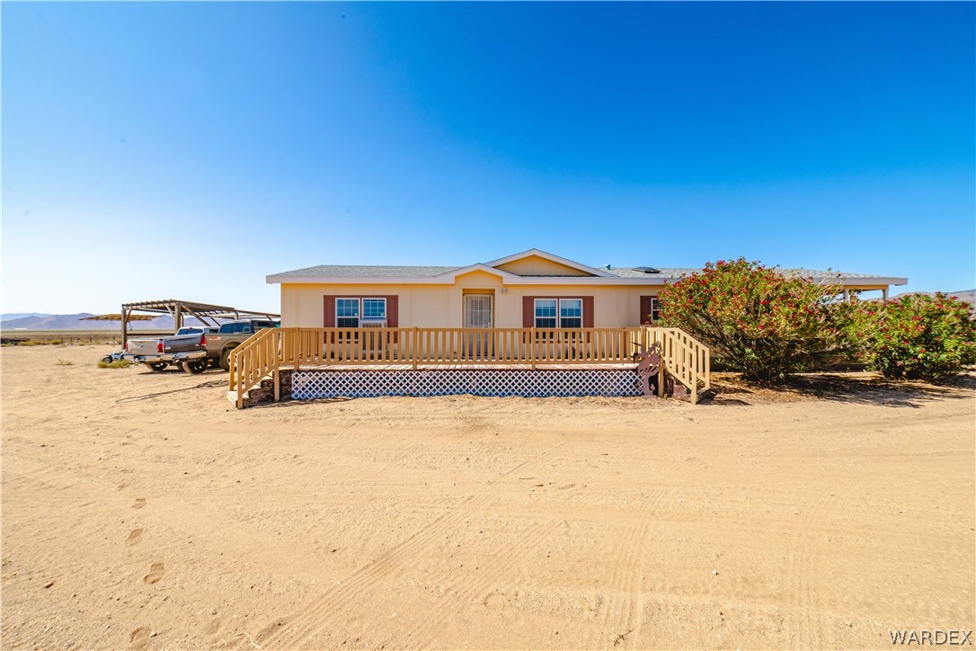 3190 East Pepper Tree Road Kingman, AZ 86409 - Photo 2 of 67 a front view of a house with a yard