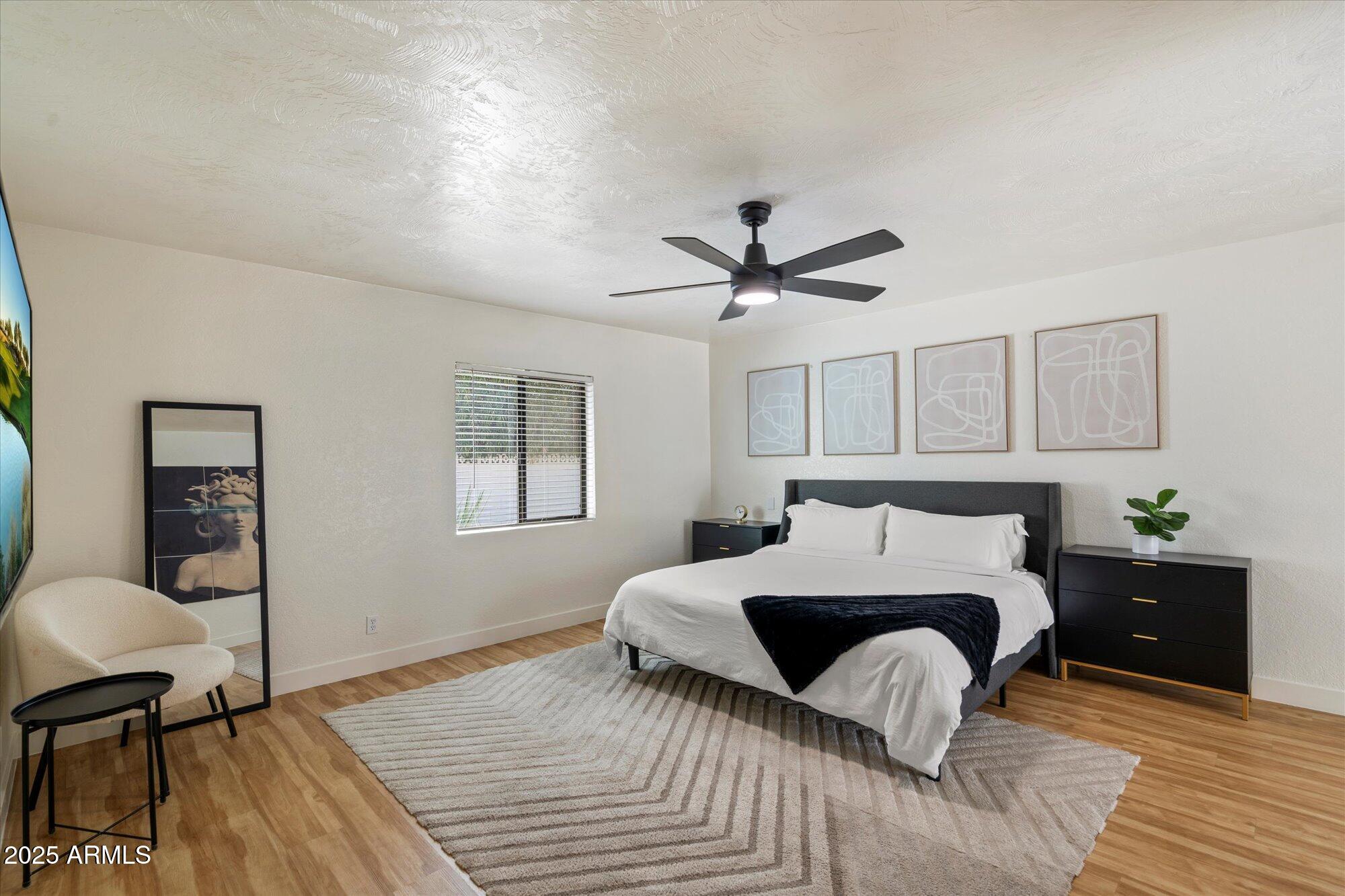 5701 East Charter Oak Road Scottsdale, AZ 85254 - Photo 11 of 27 a bedroom with a bed and a table in it
