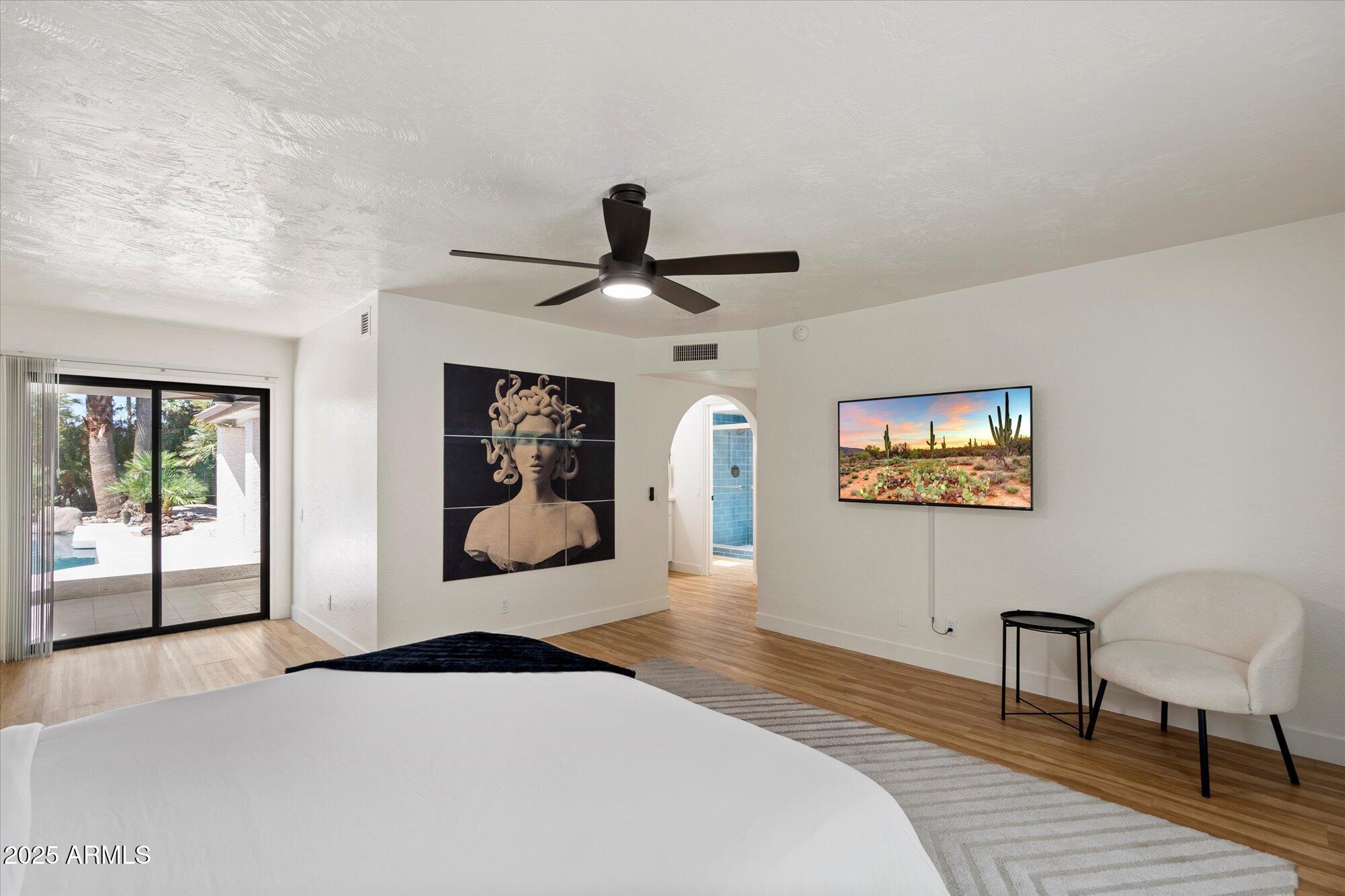 5701 East Charter Oak Road Scottsdale, AZ 85254 - Photo 12 of 27 a bedroom with a bed and a painting on the wall
