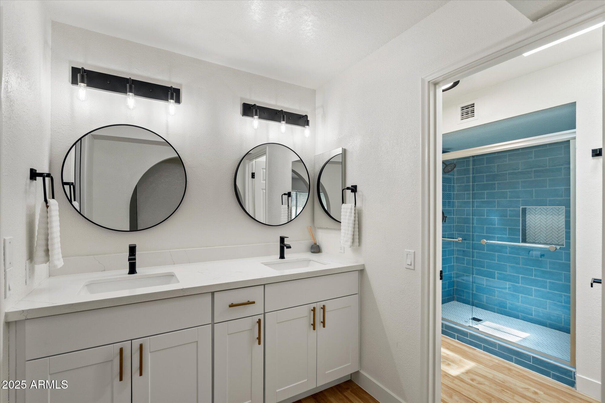 5701 East Charter Oak Road Scottsdale, AZ 85254 - Photo 13 of 27 a bathroom with a double vanity sink and a mirror