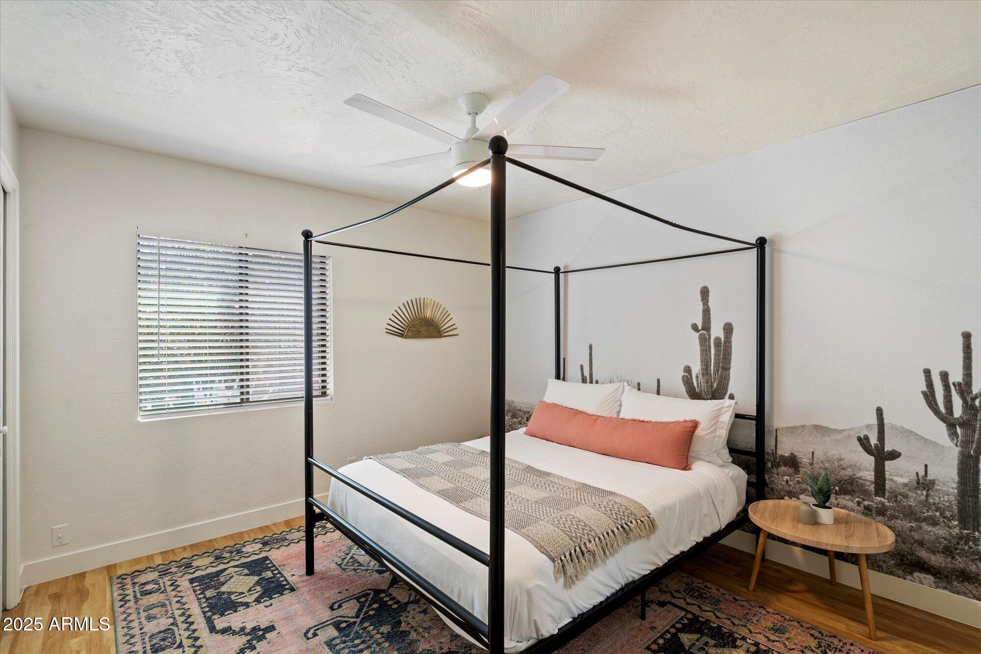 5701 East Charter Oak Road Scottsdale, AZ 85254 - Photo 14 of 27 a bedroom with a bed a lamp and a window