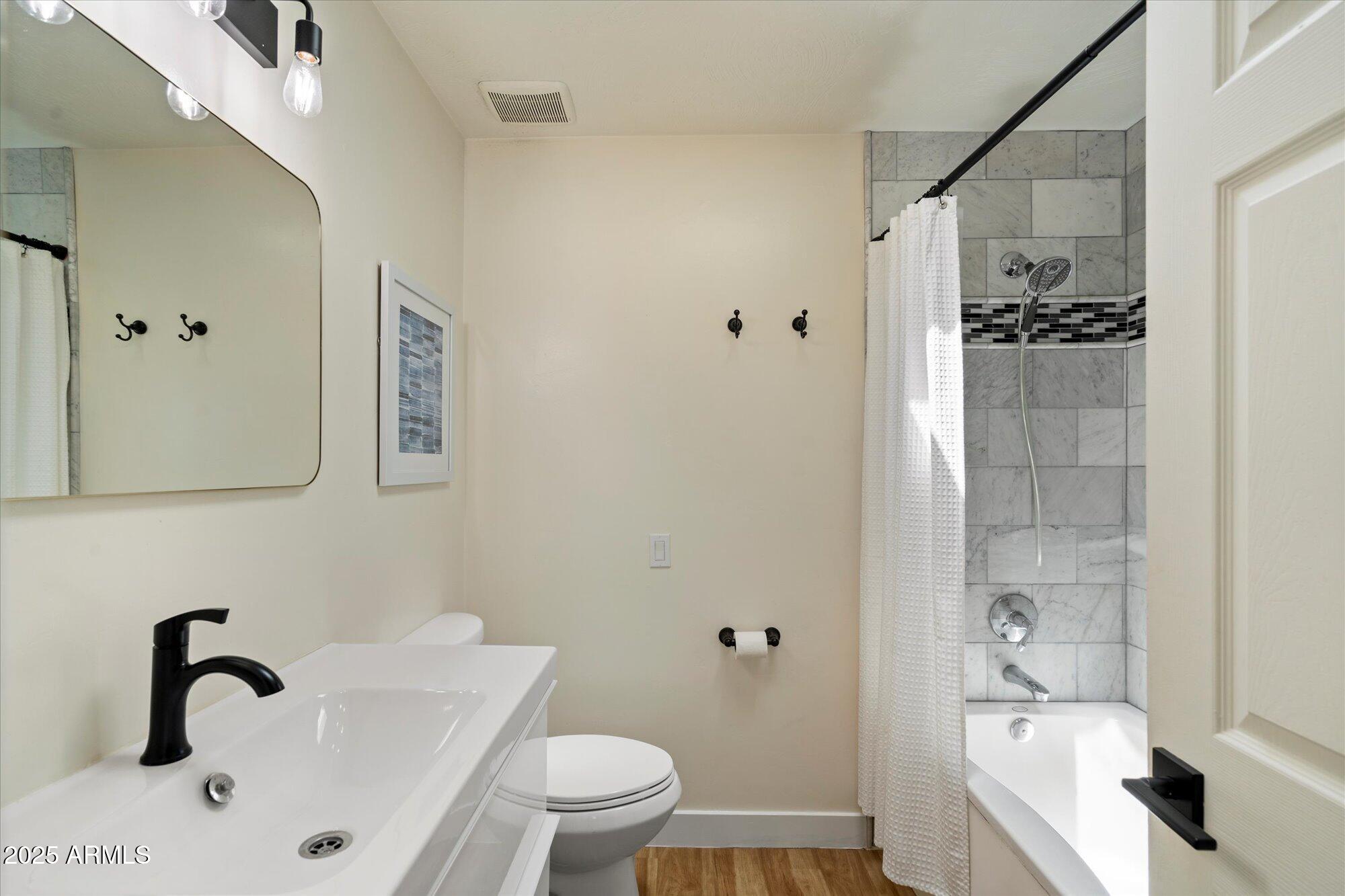 5701 East Charter Oak Road Scottsdale, AZ 85254 - Photo 15 of 27 a bathroom with a bathtub shower sink mirror and toilet