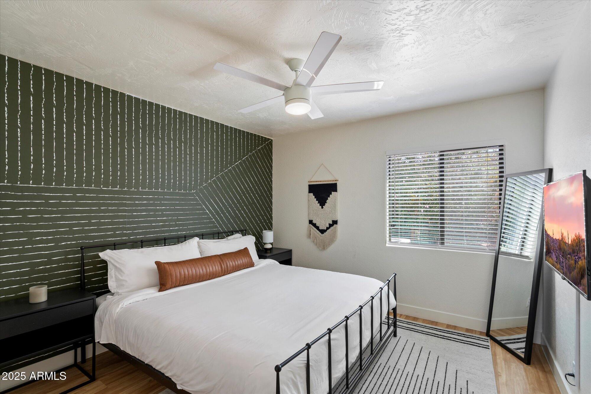 5701 East Charter Oak Road Scottsdale, AZ 85254 - Photo 16 of 27 a bedroom with a bed and a window