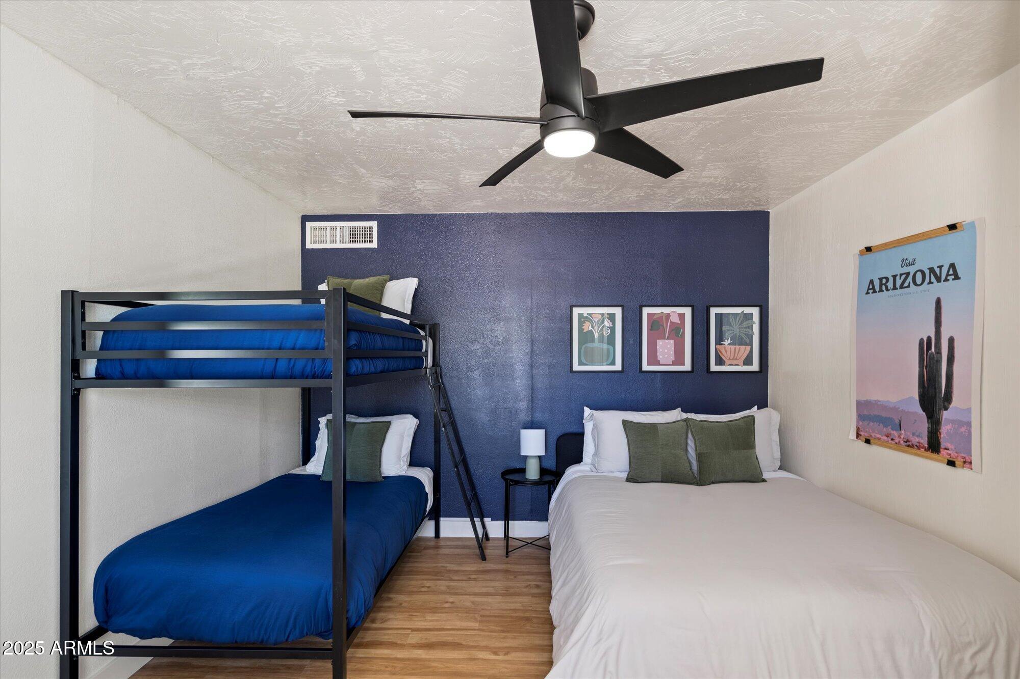 5701 East Charter Oak Road Scottsdale, AZ 85254 - Photo 19 of 27 a bed room with a bed and lamp