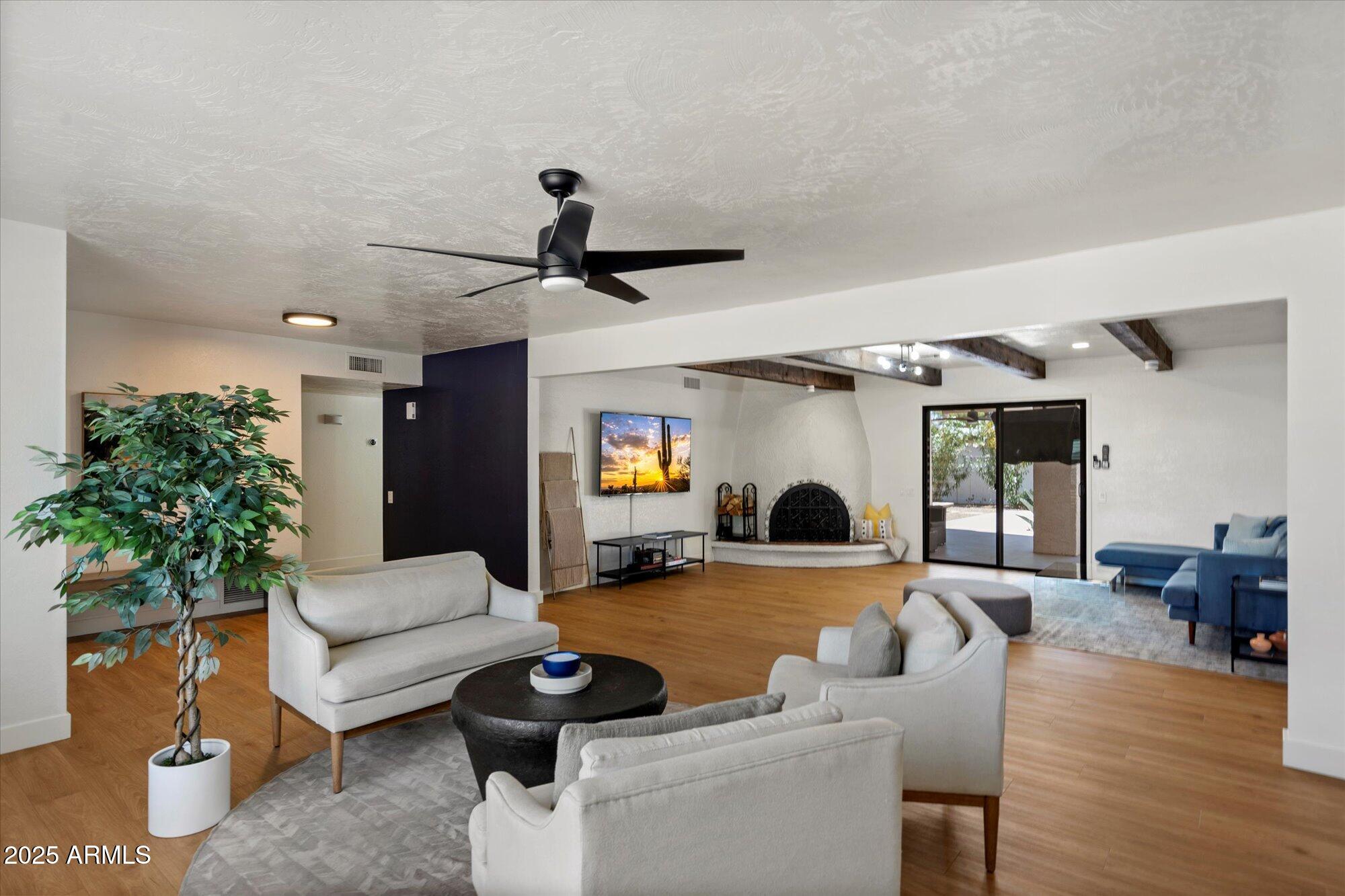 5701 East Charter Oak Road Scottsdale, AZ 85254 - Photo 2 of 27 a living room with furniture and a large window