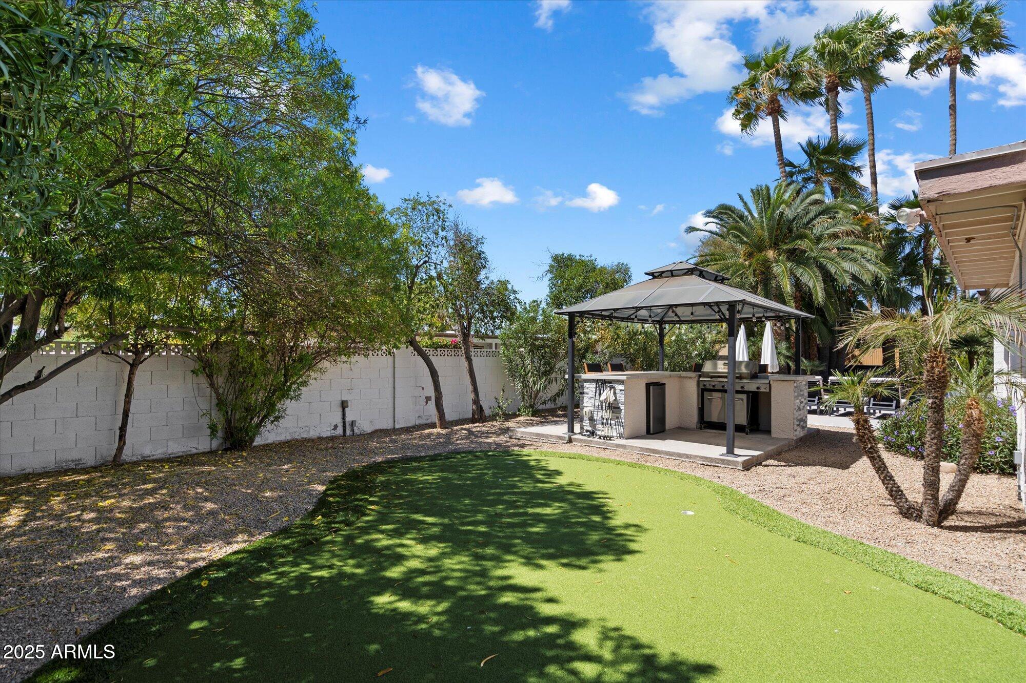 5701 East Charter Oak Road Scottsdale, AZ 85254 - Photo 21 of 27 a view of a backyard with a patio