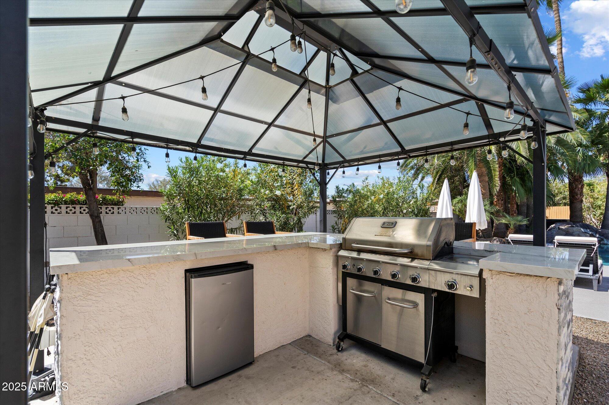5701 East Charter Oak Road Scottsdale, AZ 85254 - Photo 22 of 27 a view of a kitchen with a stove and a microwave