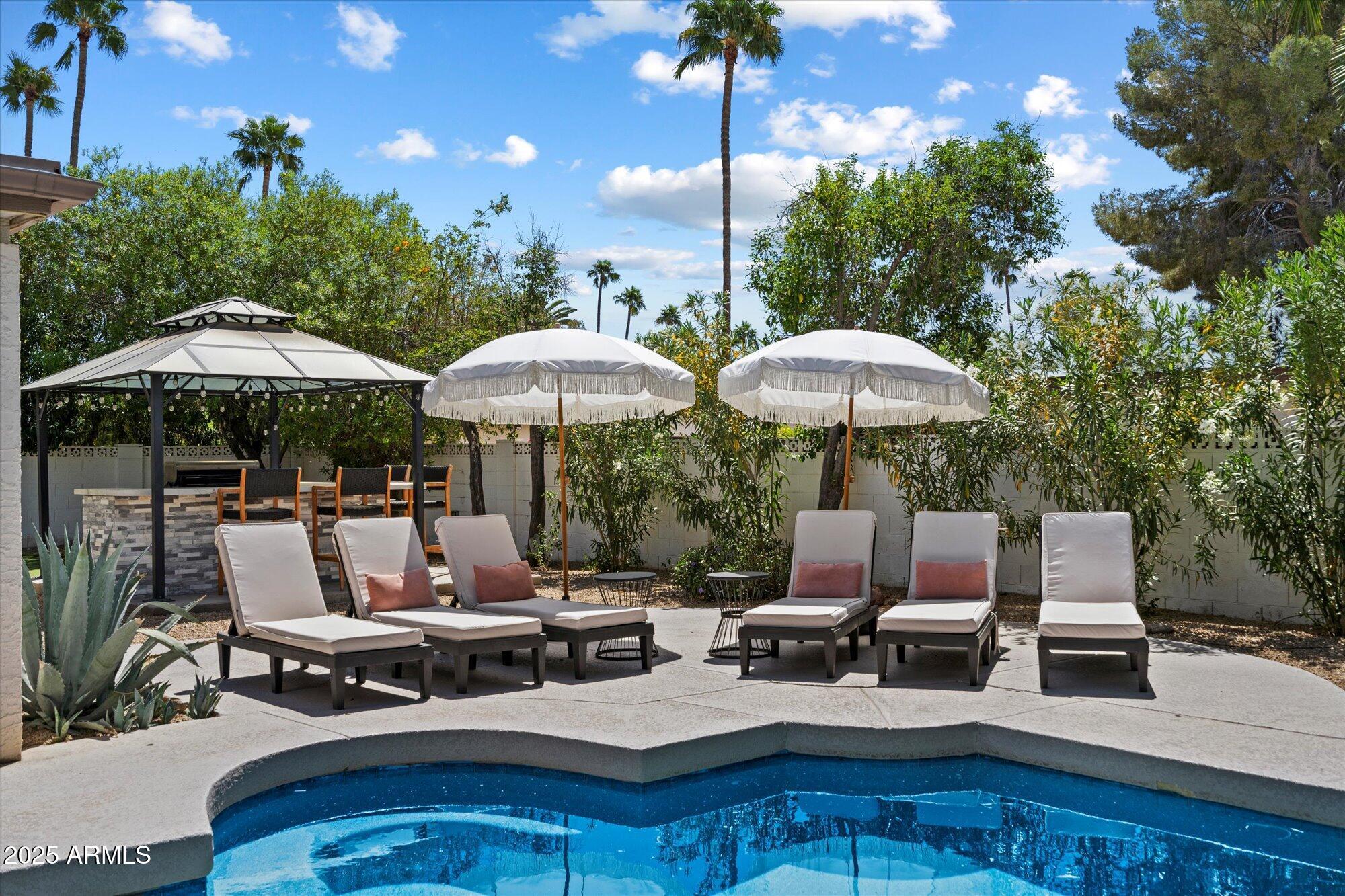 5701 East Charter Oak Road Scottsdale, AZ 85254 - Photo 24 of 27 a view of backyard with seating space and trees