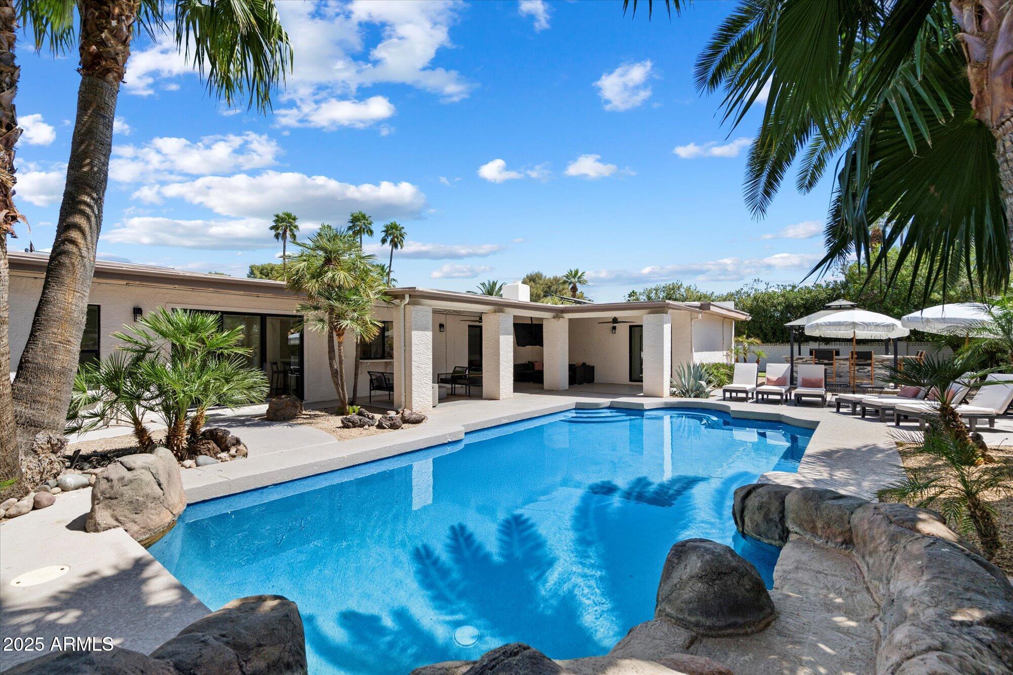 5701 East Charter Oak Road Scottsdale, AZ 85254 - Photo 26 of 27 a view of a house with swimming pool and sitting area