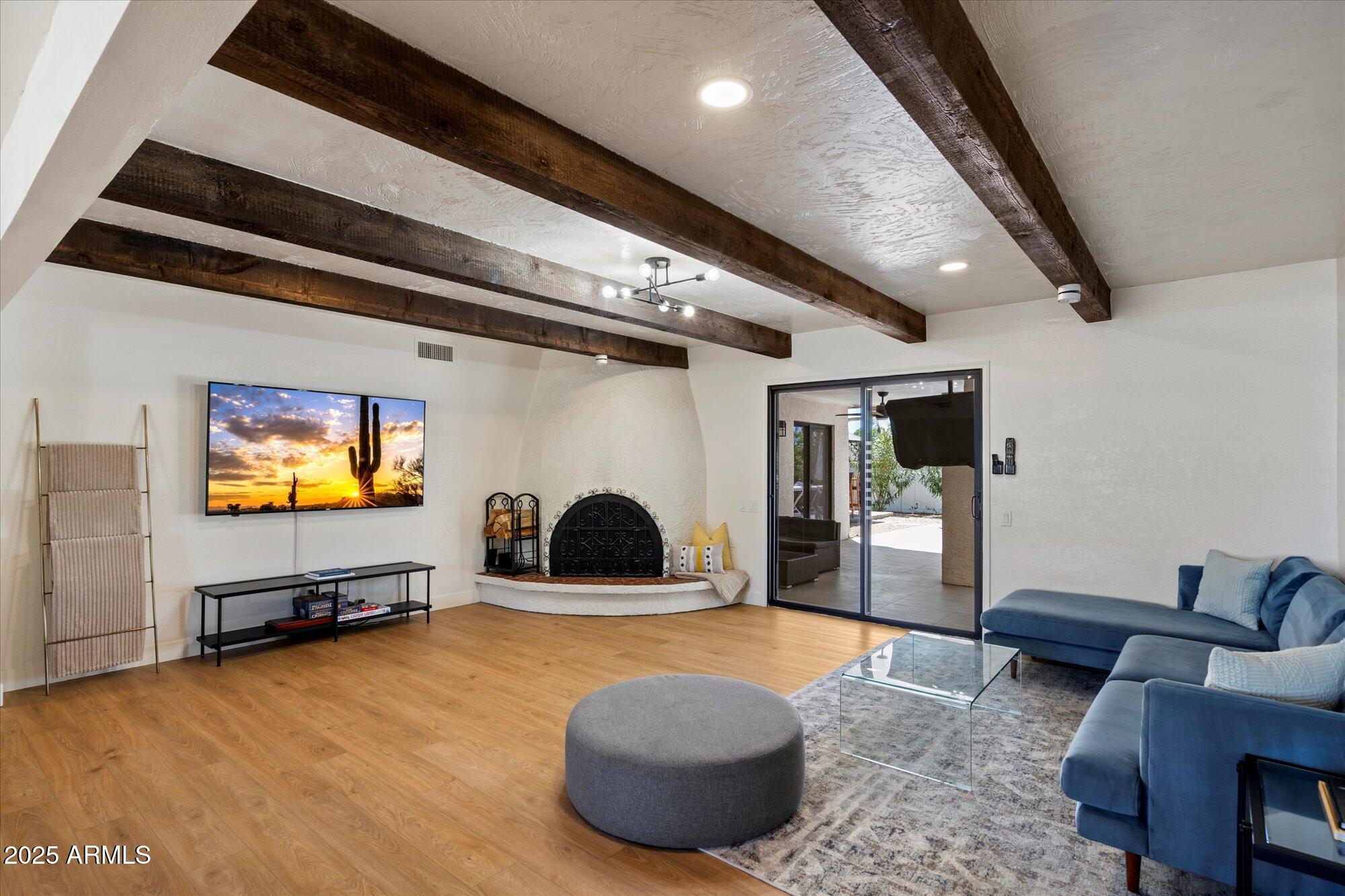 5701 East Charter Oak Road Scottsdale, AZ 85254 - Photo 3 of 27 a living room with furniture and a flat screen tv