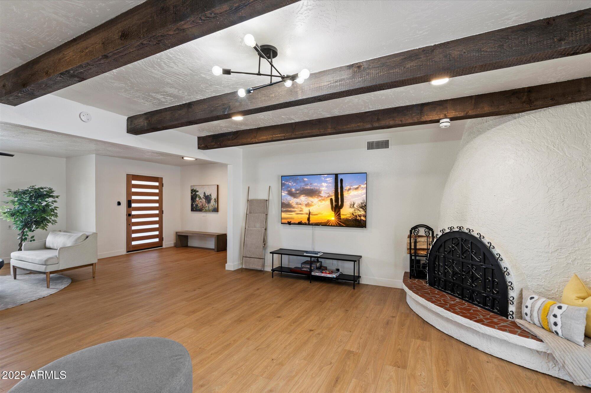 5701 East Charter Oak Road Scottsdale, AZ 85254 - Photo 5 of 27 a view of a room with gym equipment and wooden floor