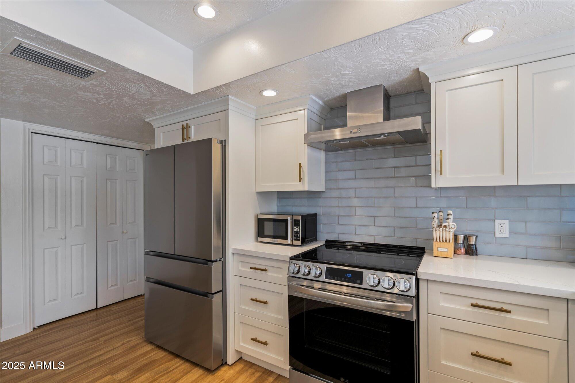 5701 East Charter Oak Road Scottsdale, AZ 85254 - Photo 7 of 27 a kitchen with a stove microwave and refrigerator