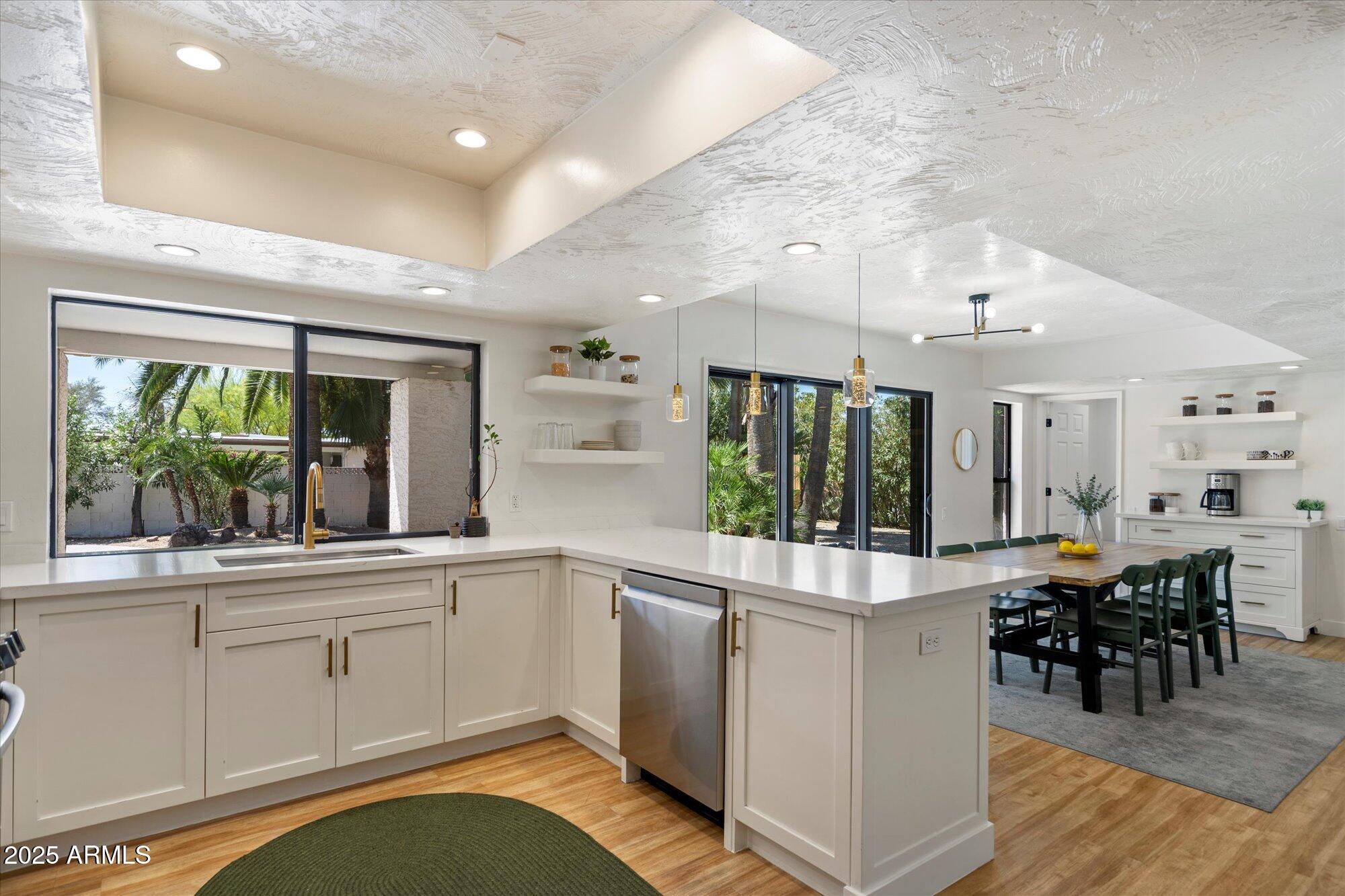 5701 East Charter Oak Road Scottsdale, AZ 85254 - Photo 8 of 27 a kitchen with stainless steel appliances granite countertop a stove and cabinets