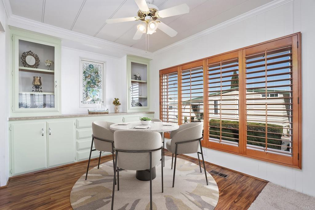 7467 Mission Gorge Road, Unit SPC 81 Santee, CA 92071 - Photo 12 of 36 a view of a dining room with furniture window and wooden floor
