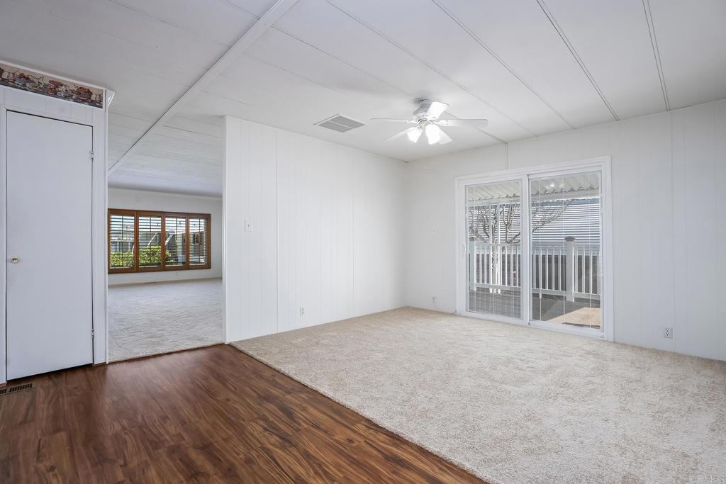 7467 Mission Gorge Road, Unit SPC 81 Santee, CA 92071 - Photo 19 of 36 a view of an empty room with a window and wooden floor