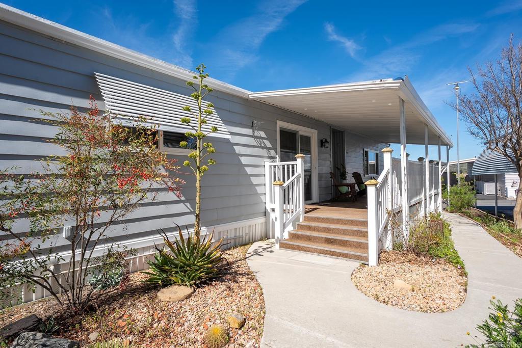 7467 Mission Gorge Road, Unit SPC 81 Santee, CA 92071 - Photo 22 of 36 a front view of a house with a yard