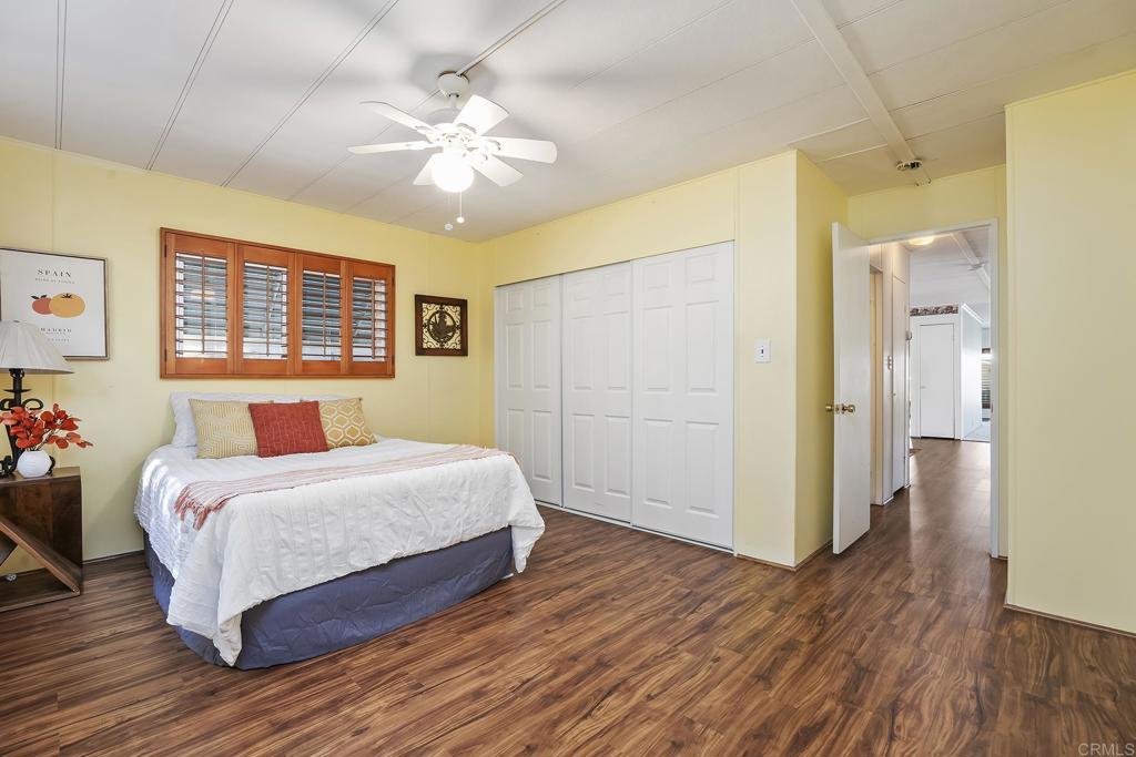 7467 Mission Gorge Road, Unit SPC 81 Santee, CA 92071 - Photo 24 of 36 a bedroom with a large bed chandelier and a window