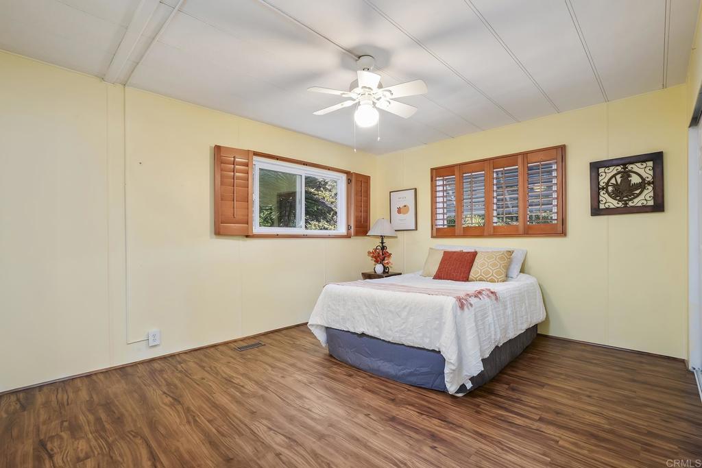 7467 Mission Gorge Road, Unit SPC 81 Santee, CA 92071 - Photo 25 of 36 a bedroom with a large bed chandelier and a window