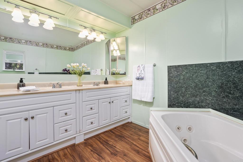 7467 Mission Gorge Road, Unit SPC 81 Santee, CA 92071 - Photo 27 of 36 a spacious bathroom with a granite countertop sink mirror and bathtub
