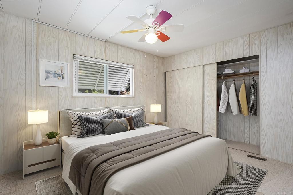 7467 Mission Gorge Road, Unit SPC 81 Santee, CA 92071 - Photo 30 of 36 a bedroom with a bed and a painting on the wall