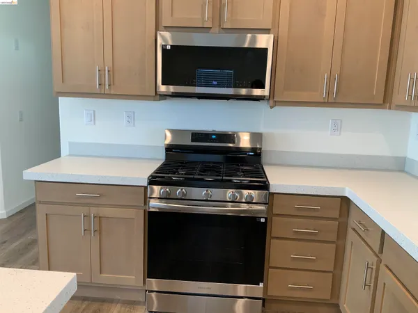 a room with kitchen island and wooden floor