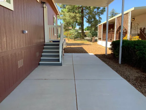 a view of a porch with wooden floor and stairs