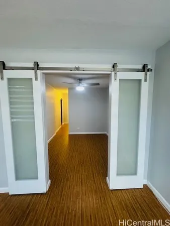 a view of walk in closet with wooden floor