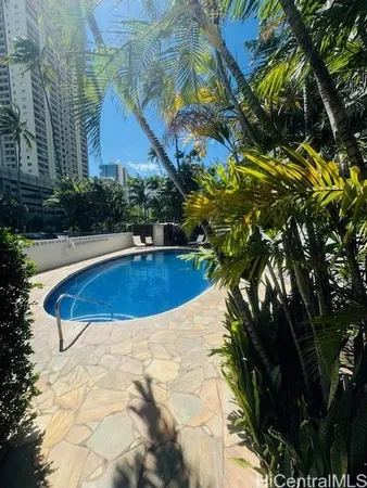 a view of a swimming pool with a yard