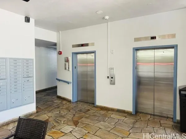 a view of a hallway with wooden cabinets