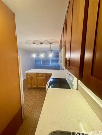 a kitchen with a sink and wooden floor