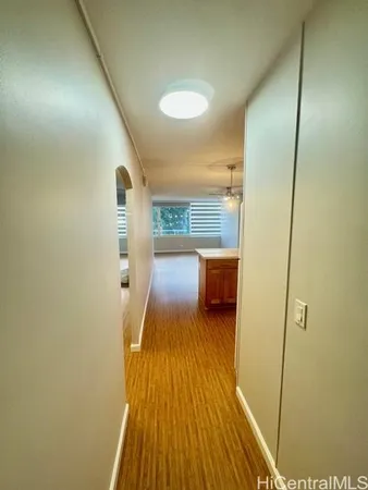 a view of a hallway with wooden floor