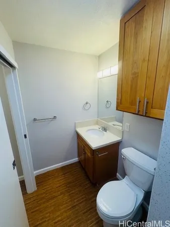 a bathroom with a sink and mirror with toilet
