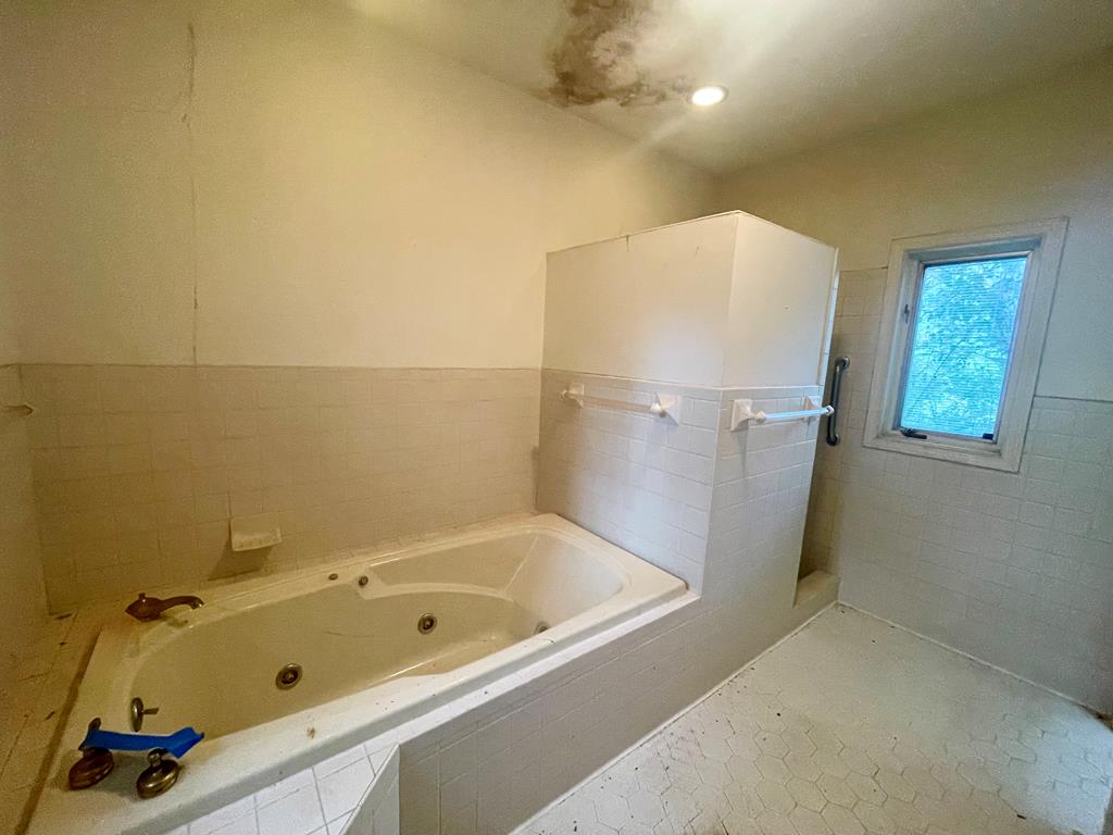 574 Old Chipley Road Pine Mountain, GA 31822 - Photo 23 of 61 a bathroom with a tub and a shower