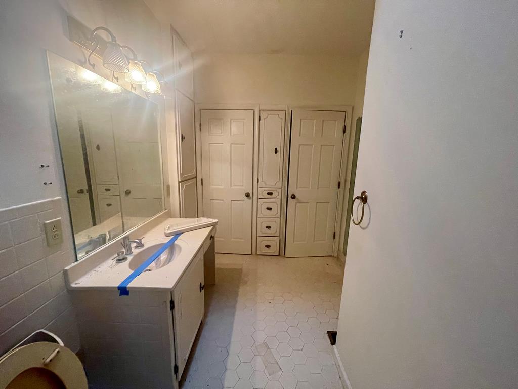 574 Old Chipley Road Pine Mountain, GA 31822 - Photo 24 of 61 a bathroom with a double vanity sink toilet and shower