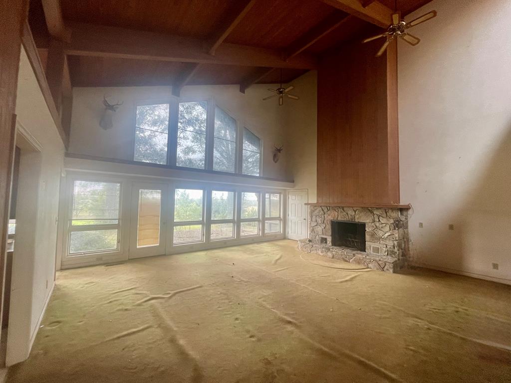 574 Old Chipley Road Pine Mountain, GA 31822 - Photo 4 of 61 a view of an empty room with a fireplace and a window