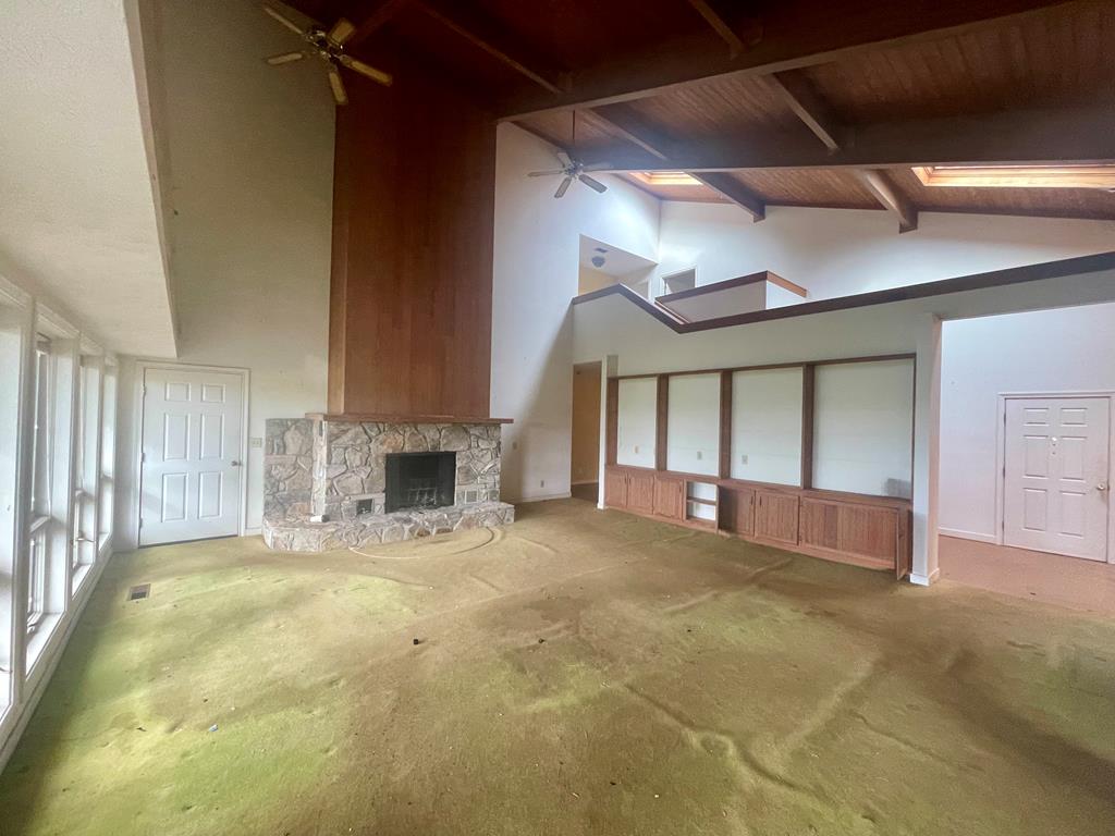 574 Old Chipley Road Pine Mountain, GA 31822 - Photo 5 of 61 a view of an empty room with a fireplace and a window