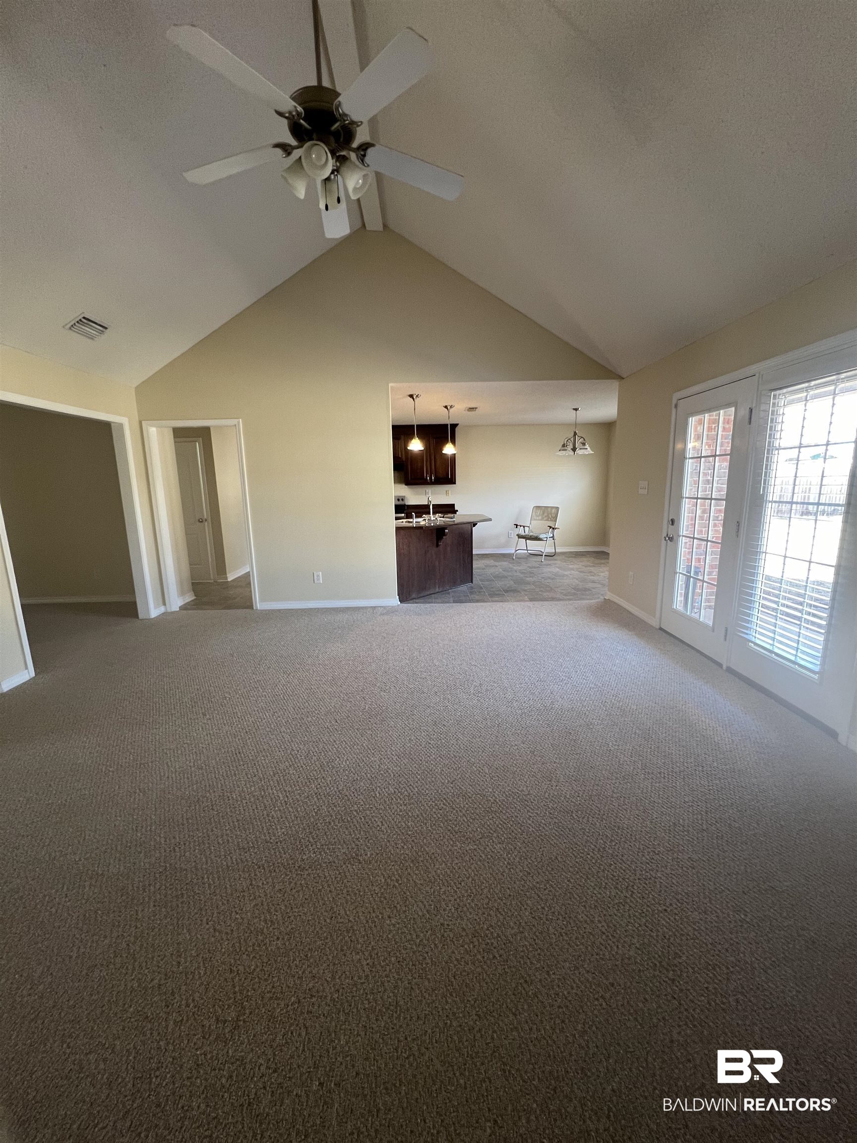 17793 Fancy Boulevard Foley, AL 36535 - Photo 14 of 34 Unfurnished living room with ceiling fan, lofted ceiling, and carpet flooring