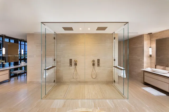 a bathroom with a glass shower door