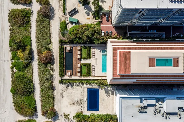a view of a house with potted plants and a floor to ceiling window