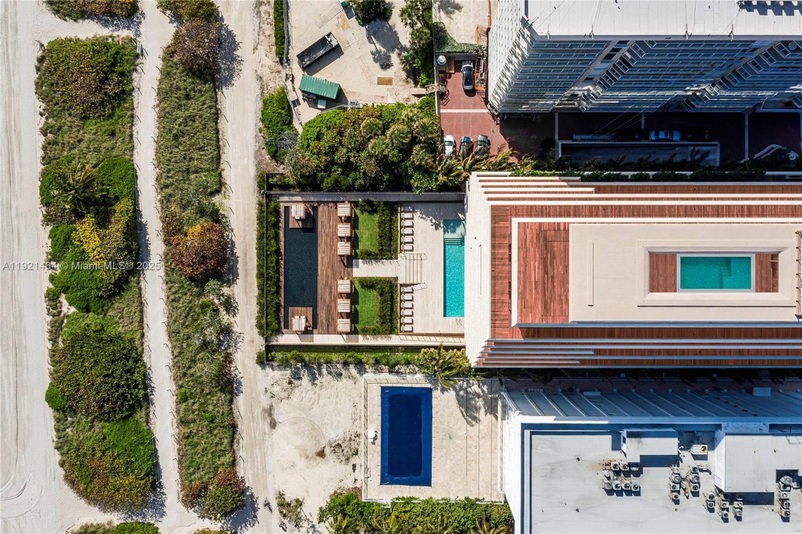 8955 Collins Avenue, Unit 402 Surfside, FL 33154 - Photo 19 of 20 a view of a house with potted plants and a floor to ceiling window