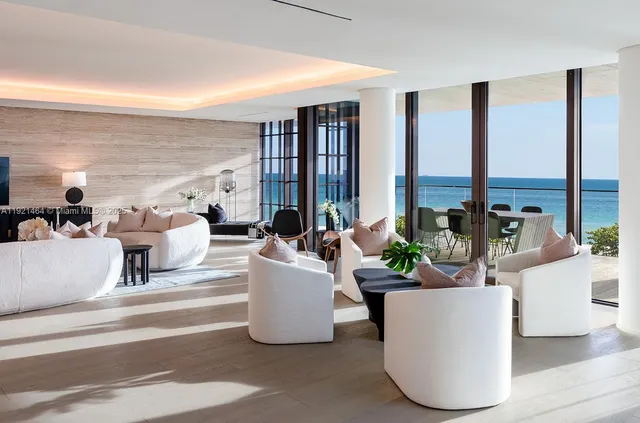 a living room with furniture and large windows