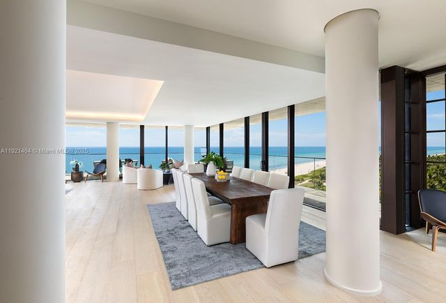 a living room with couches a coffee table and a large window with outer view