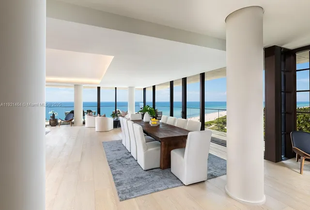 a living room with couches a coffee table and a large window with outer view