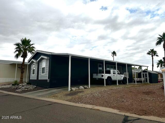 2000 South Apache Road, Unit 296 Buckeye, AZ 85326 - Photo 17 of 23 a view of a house with a backyard and porch