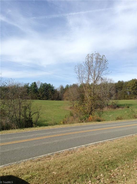 1 Mears Road Mount Airy, NC 27030 - Photo 4 of 12 Two-lane paved Mears Rd. picturing level cleared land. This well-maintained field has been cut for hay.