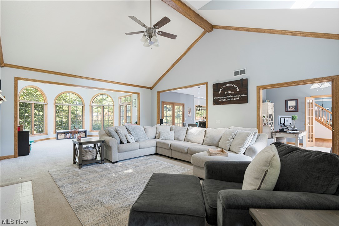 939 Pontius Road Mogadore, OH 44260 - Photo 26 of 35 Carpeted living room with plenty of natural light, beamed ceiling, vaulted ceiling high, and ceiling fan