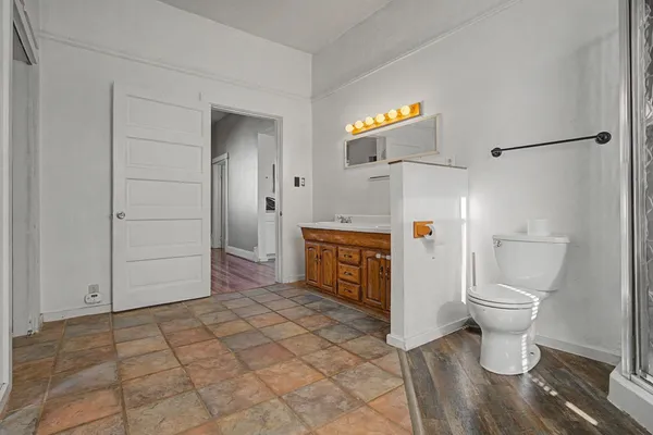 a bathroom with a sink a toilet and a shower