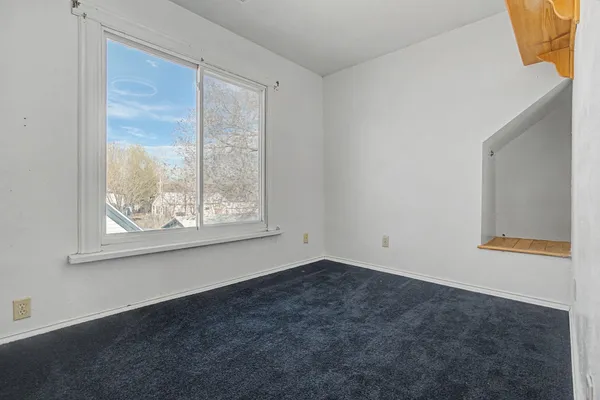 a view of a hallway to rooms and wooden floor