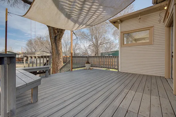 a view of outdoor space with wooden floor and windows